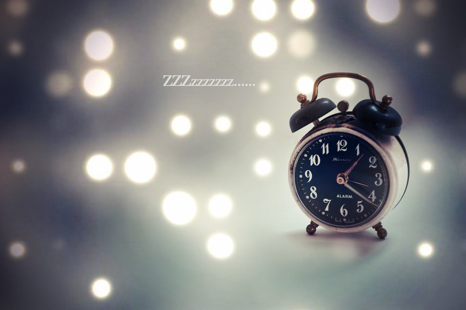 Réveil posé près d'un lit dans une ambiance nocturne